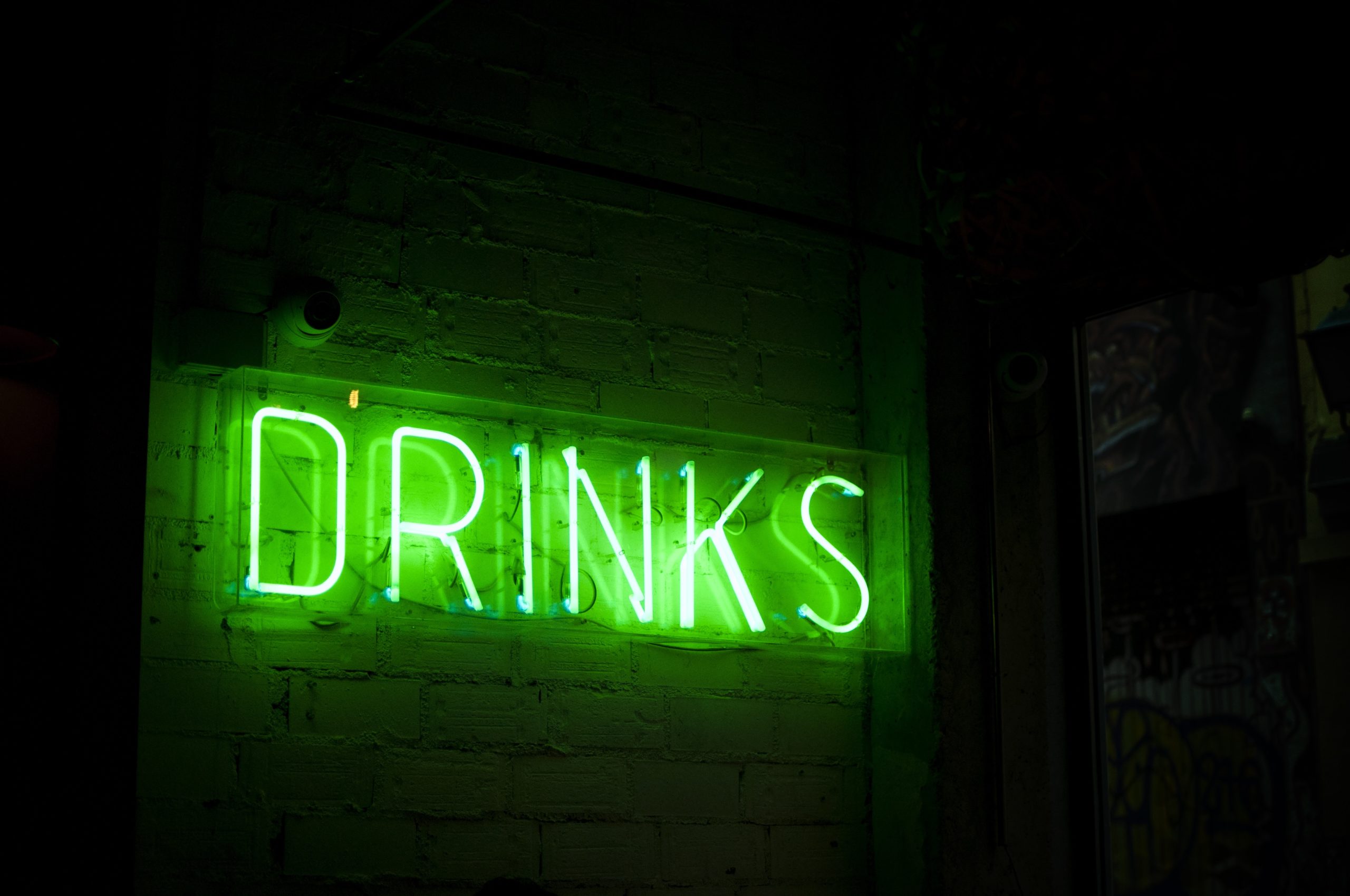 Neon green drinks sign