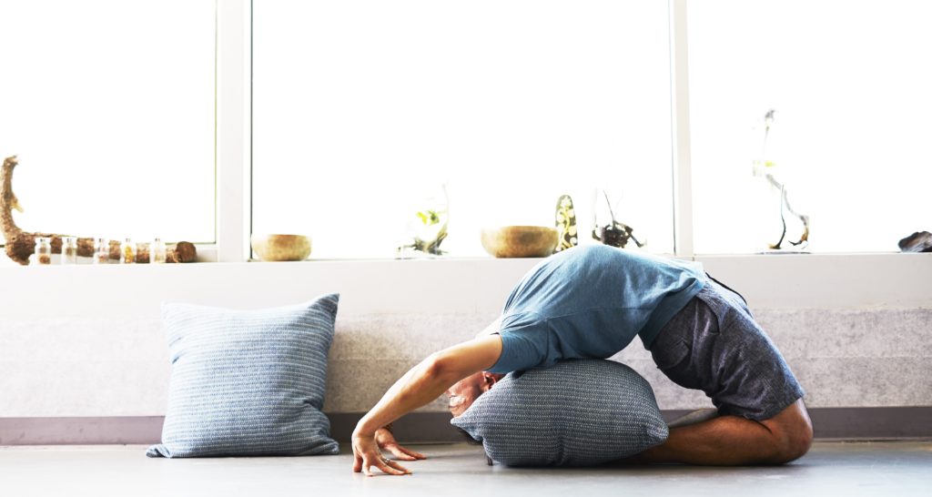 Man doing yoga at home