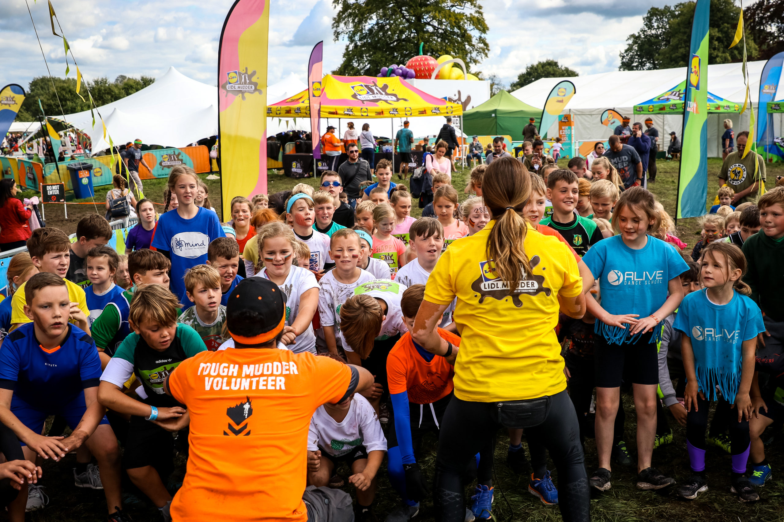 Volunteer stands in front of kid participants