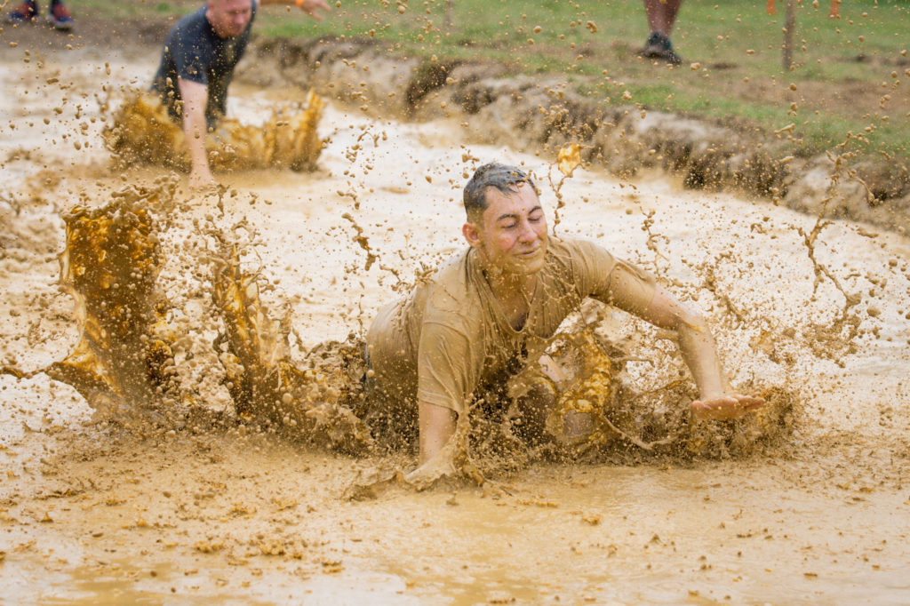 Participant swimming in the mud