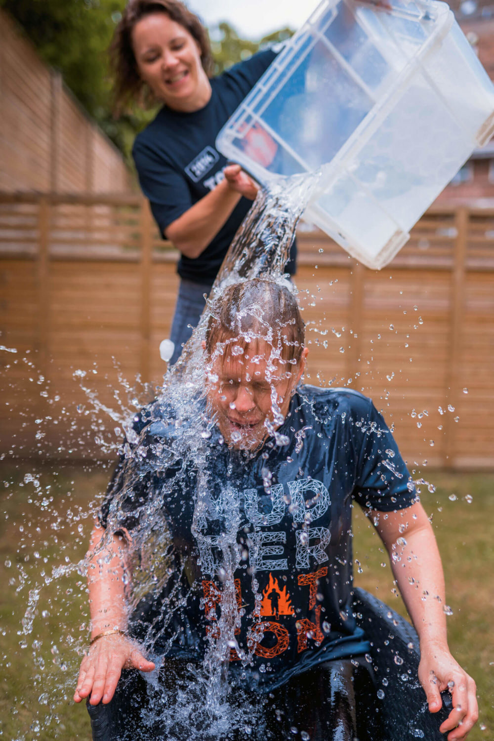 Participant pouring water to another participant