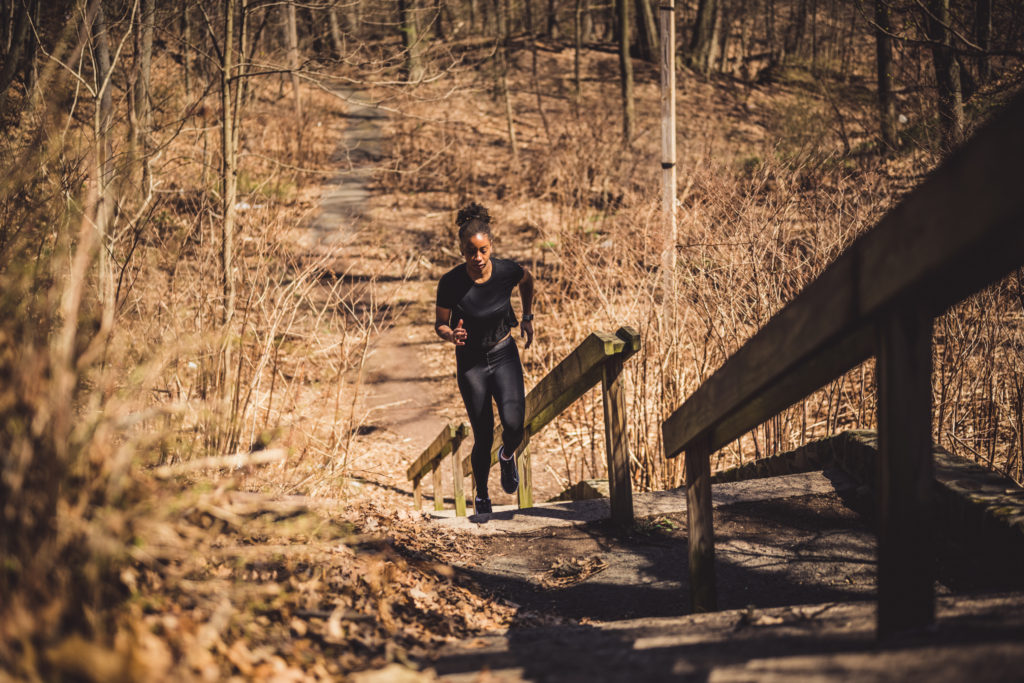woman running up steps on trails