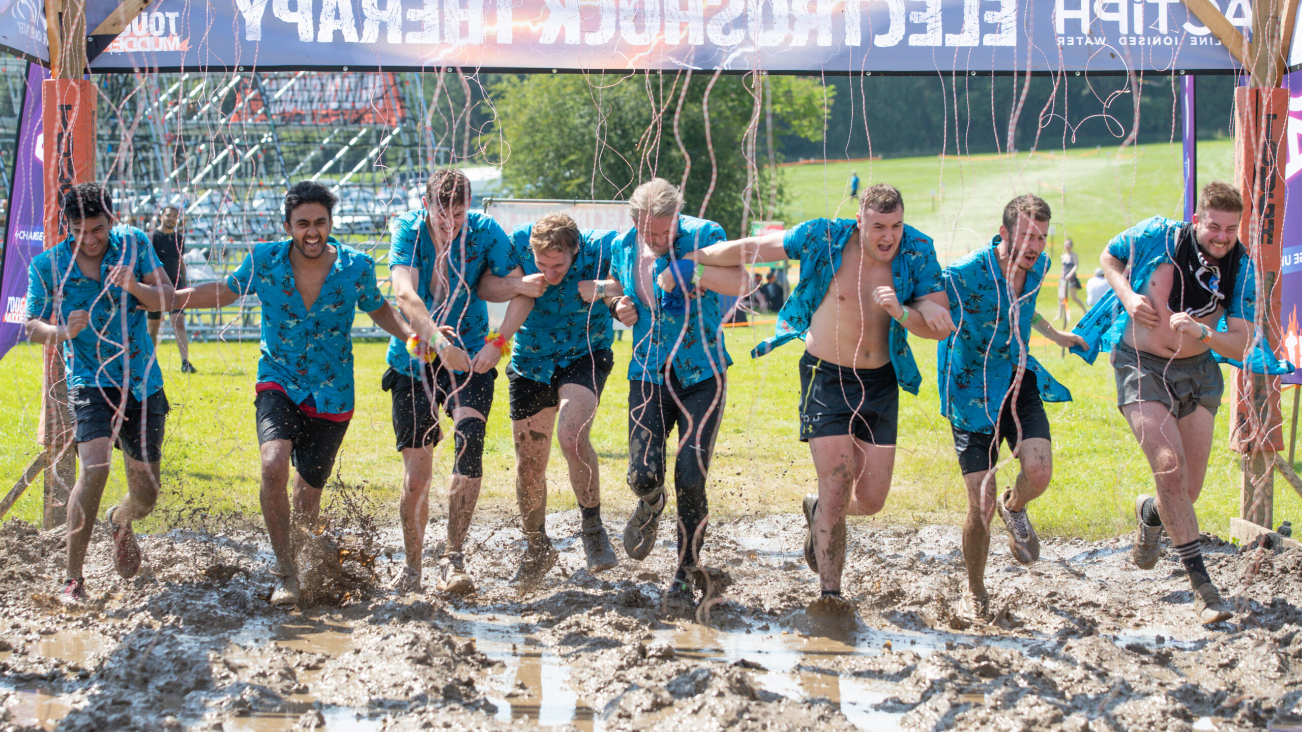team running obstacle at London West event